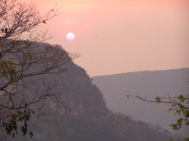 Watching the sun sink down to Lake Tanganyika through the gorge over the gorge below the waterfall, from campsite