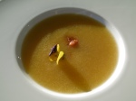 Peach soup with floral garnish